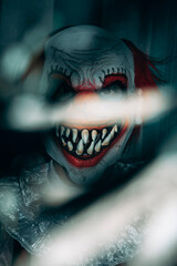 mad evil clown staring at the observer at night