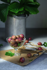 Ripe red gooseberries in a vintage vase. Vintage rustic rustic concept