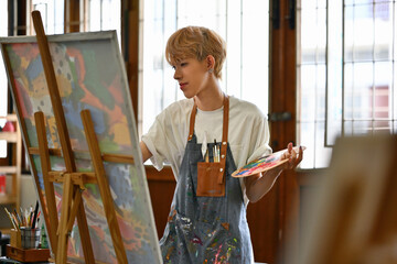 Young Asian LGBT artists doing artwork in the workshop studio