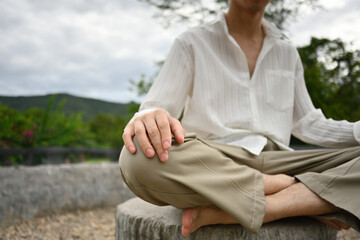 Naklejka na ściany i meble Close-up image of Young Asian man meditating