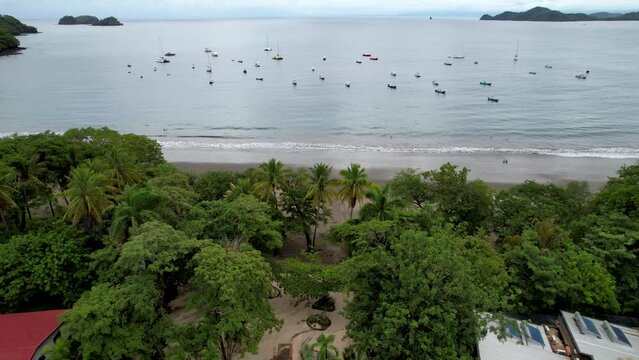 Beautiful aerial footage of Playas del Coco, Hermosa Beach and its green mountains, bay and yachts in Costa Rica
