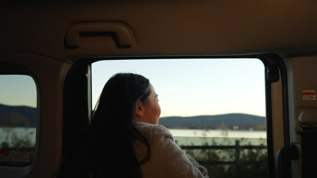 Asian Woman Looking Beautiful Nature Out Of Car Window During Travel Road Trip In Japan. Attractive Girl Enjoy Outdoor Lifestyle Travel Lake Kawaguchi And Mt Fuji Covered In Snow On Holiday Vacation.