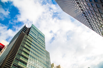 Fototapeta na wymiar Window office building in Tokyo city against blue sky with cloud