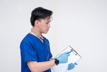 Portrait of a young and serious medical student, intern, nurse writing something at a checklist board. Isolated on a white background.