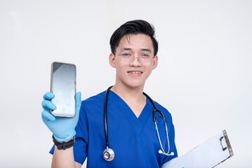 Portrait of a young and cheerful medical student, intern, nurse holding a phone. Isolated on a...