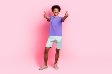 Full length photo of impressed man with afro hairstyle dressed blue t-shirt showing thumbs up good work isolated on pink color background