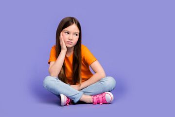 Full size photo of minded sad schoolgirl wear stylish t-shirt denim trousers sit look empty space...