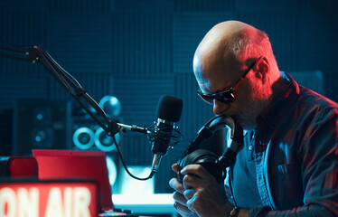 Pensive radio presenter in the radio studio