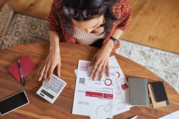 Woman calculating financial bill at home - 642089184