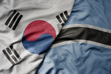 big waving national colorful flag of south korea and national flag of botswana .