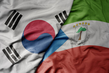big waving national colorful flag of south korea and national flag of equatorial guinea .