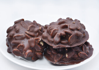 Chocolate chip cookies with nuts. Sweet appetizer on a white plate.