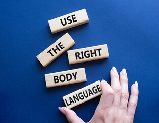 Use the righ Body Language symbol. Concept words Use the righ Body Language on wooden blocks. Businessman hand. Beautiful deep blue background. Business concept. Copy space