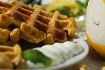 Breakfast on the table Viennese waffles, tea with lemon,