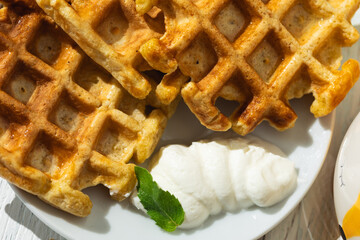 Breakfast on the table Viennese waffles, tea with lemon,