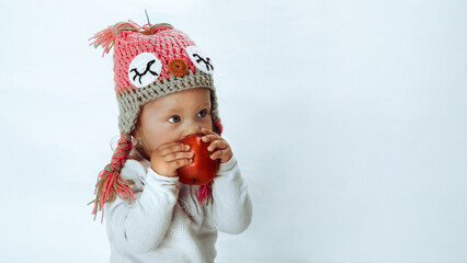 Baby girl enjoying aroma of an apple