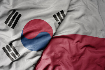 big waving national colorful flag of south korea and national flag of poland .