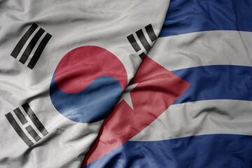 big waving national colorful flag of south korea and national flag of cuba .