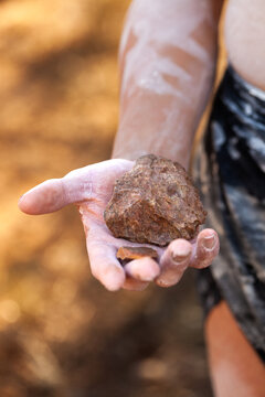 Close up of Aboriginal artefact held in hand axe head or cutting rock stone