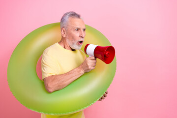 Photo retired sportive man holding megaphone speech proclaim bring rubber inflatable circle stop swimming isolated on pink color background - Powered by Adobe