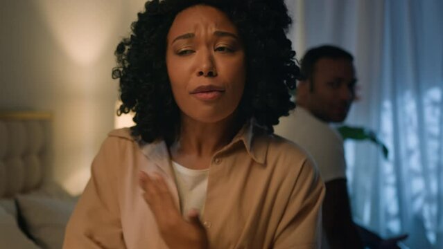 Annoyed angry mad African American ethnic couple husband wife sit apart on bed at night fight family quarrel relationship problem argue shouting arguing conflict breakup trouble erectile dysfunction