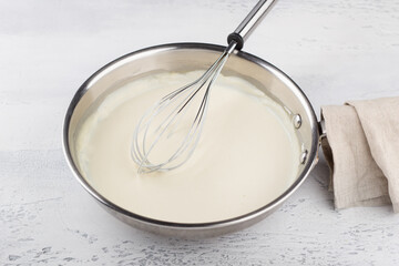 Making cheese sauce for pasta. Add milk and mix until creamy. DIY step by step step 6 - 642098375