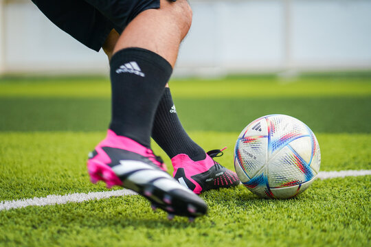 Thailand - 26 August 2023: A football player is wears Adidas "Predator Accuracy", training football on artificial grass pitch. Object and sport activity editorial.