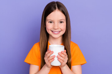 Portrait photo of optimistic little cute daughter kid childhood holding cup warm cacao tasty beverage isolated on violet color background