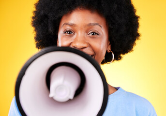 Happy black woman, portrait and megaphone in advertising or marketing against a yellow studio...