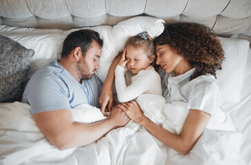 Top view, family and parents with child in bed for bonding, healthy relationship and sleeping at home. Morning, love and above of mother, father and girl in bedroom asleep for comfort, cuddle or love