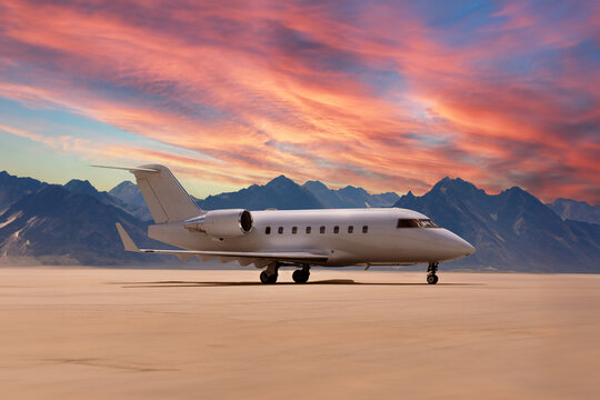luxury private jet park on ground in desert with mountains in background while sunset ready to start and fly rich VIP business people in this jetlinder