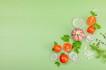 Culinary background with fresh vegetables and herbs. Tomatoes cherry, purple onion rings