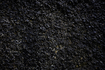 Black or dark gray rough grainy stone texture background