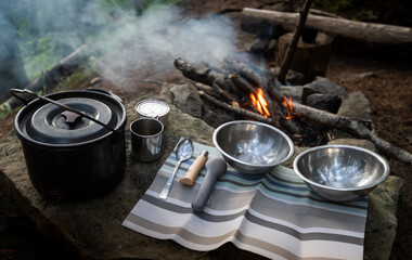 Сamping food cooking outdoor on fire in a cauldron