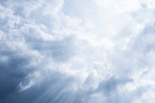 Sky background. The rays of the sun break through dense dramatic clouds