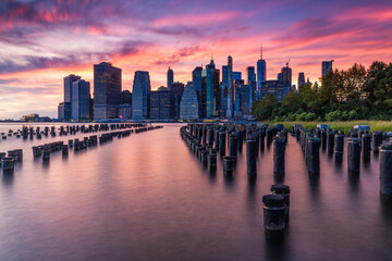 Sunset over lower Manhattan as seen from Brooklyn Bridge Park, New York City.