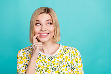 Photo of friendly cute woman with bob hairstyle dressed t-shirt finger on teeth dreamy look empty...