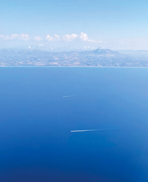 Mediterranean landscape with sea and boats view from a plane, Sicily coast seen from above