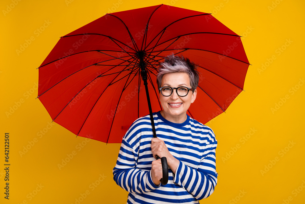 Canvas Prints Photo of cheerful adorable lady wear striped sailor shirt hold umbrella enjoy walk isolated on yellow color background