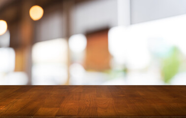 Mock up for space. Empty dark wooden table in front of abstract blurred bokeh background of restaurant . can be used for display or montage your product