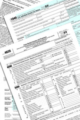 2023 IRS tax forms stacked on a desk top.