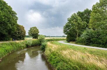 Fototapeta na wymiar Trees reflecting in the bending River Demer, Flanders, Belgium