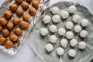 Delicious homemade white chocolate and brown caramel truffles with almonds and nuts in a retro...