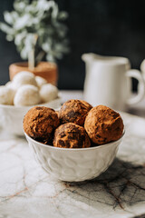 Beautiful and delicious homemade cocoa dusted chocolate truffles with dark chocolate in a retro grunge style.