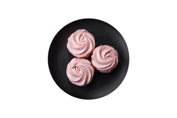 Delicious sweet colored marshmallow on a dark concrete background