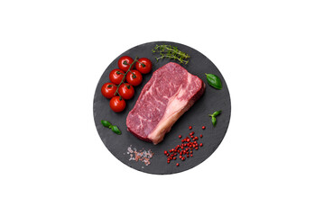 Fresh raw beef striploin steak with salt, spices and herbs