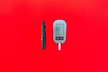 Medical device and diabetes concept - blood glucose meter with lancets