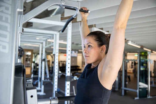 Healthy woman working out in a gym for exercise. 