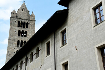 Fototapeta na wymiar The collegiate church of Santi Pietro e Orso is a Romanesque religious complex in Aosta; the bell tower and the ancient cloister are beautiful in Aosta Valley.