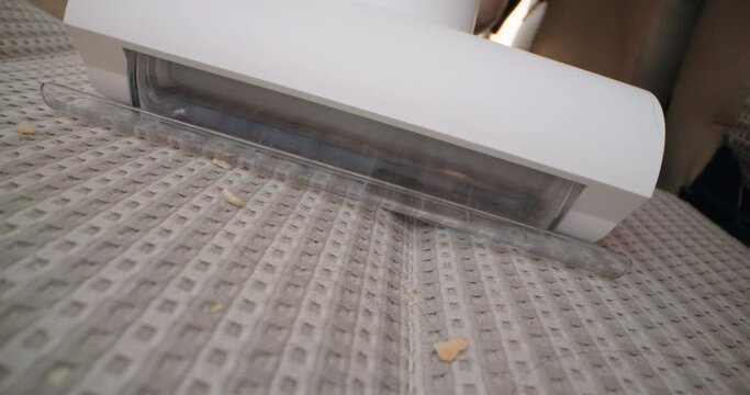 Close-up of cleaning the car seat with a vacuum cleaner. A woman's hand vacuums the car at home. High quality 4k footage